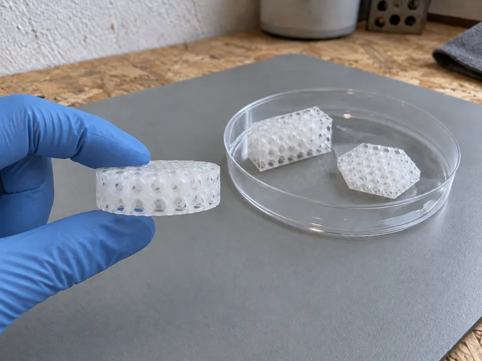 Handling a sample to show its thickness.