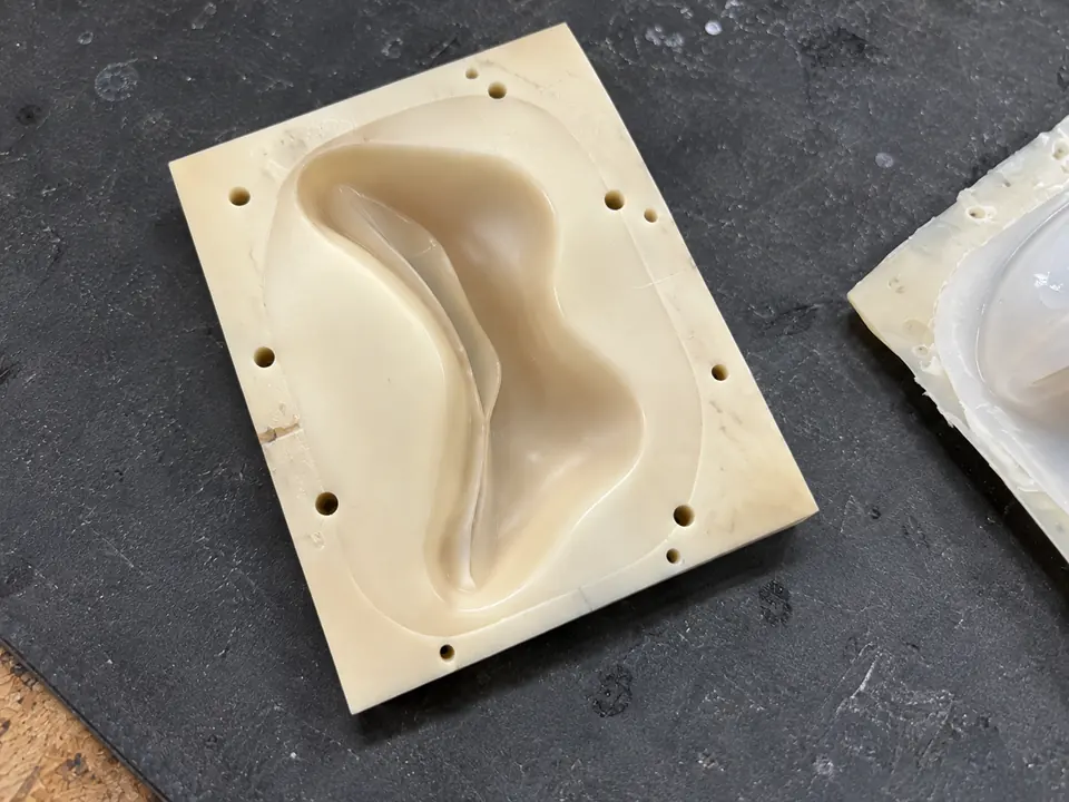 One mould face, with the cast part beside it.