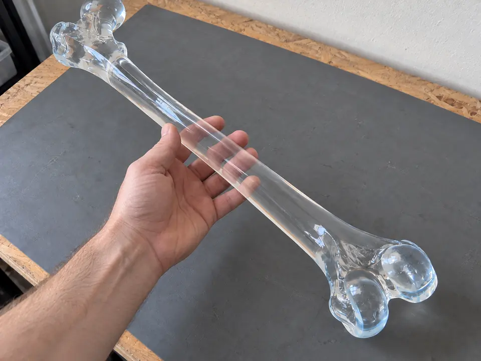 A hand visible through the clear resin.